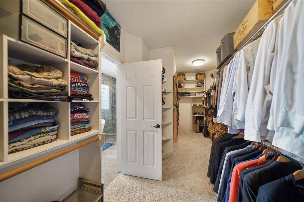 Enormous primary closet with built ins for added storage!