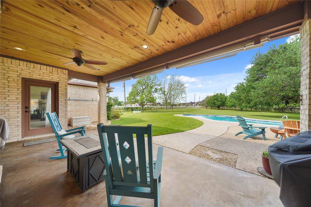 Relax on the extensive back patio under with custom ceiling and updated fans and enjoy your acreage views.