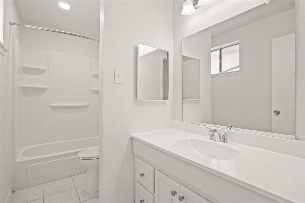 The primary en-suite bath with large vanity offers plenty of storage space.