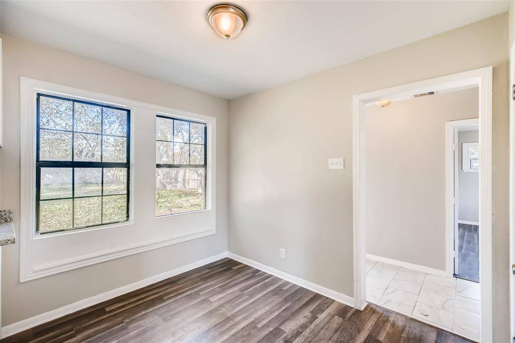 Breakfast nook looks out to the backyard. Opening on the right leads to the backdoor, laundry room and master bedroom.