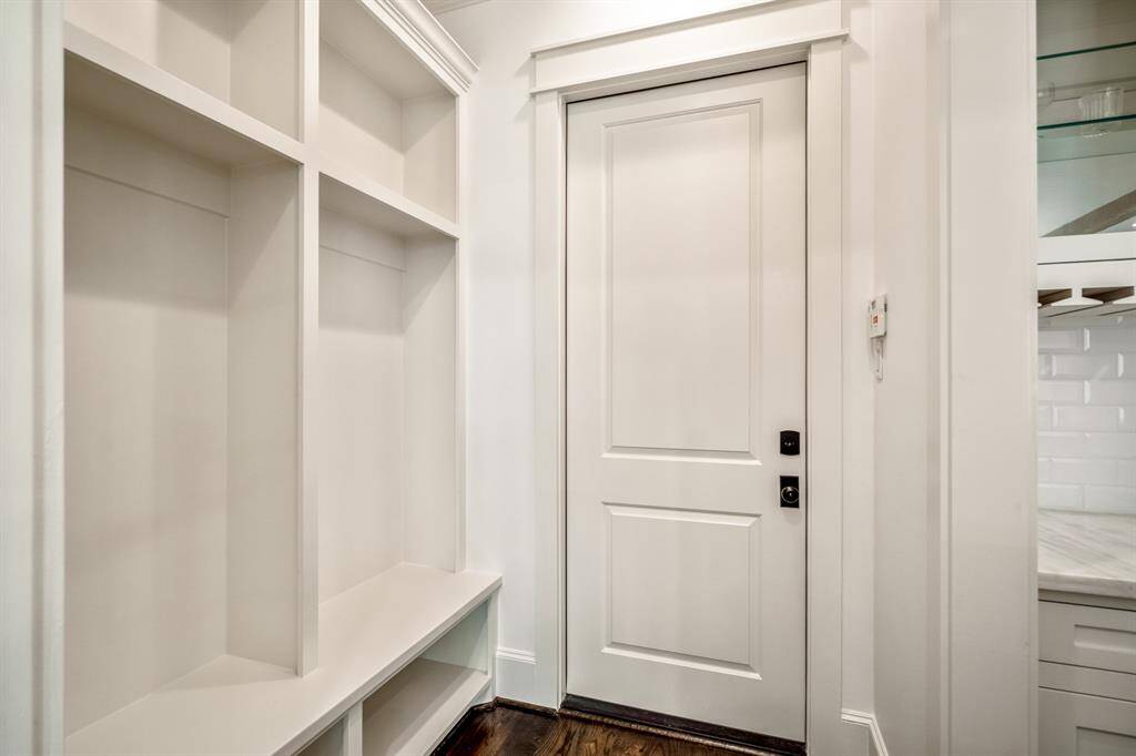 The custom-designed mudroom offers everyday functionality with timeless appeal, featuring built-in cubbies and seating that make comings and goings seamless for the whole family.