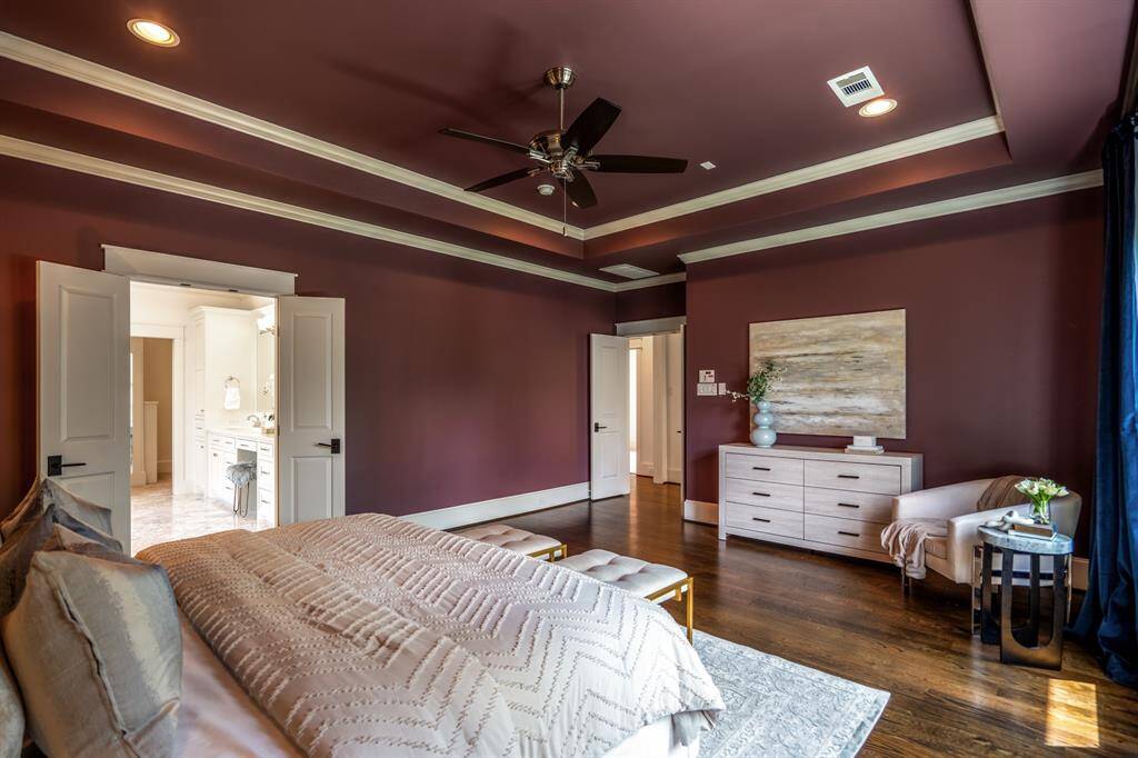 With a palette that’s bold yet serene, this primary suite exudes hotel-level comfort. Double doors open to your marble-wrapped en suite retreat.