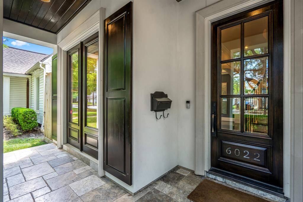 This entry is equal parts function and finesse. A closer look at the recently re-stained front door & shutters reveals artisan-crafted woodwork and window panes that allow soft natural light to filter through into the foyer.