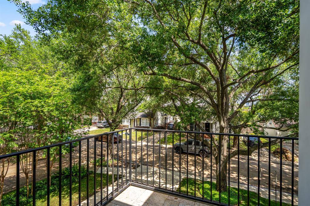 Step out into the upstairs balcony for some fresh air, where leafy treetop views offer a serene perspective on this charming, walkable, family-friendly neighborhood.