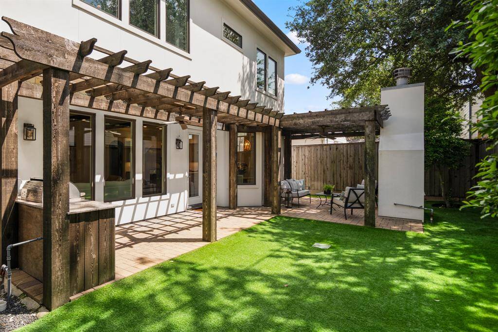 Low-maintenance turf and mature landscaping define a tidy, enclosed backyard, ideal for kids, pets, or weekend gatherings with friends.