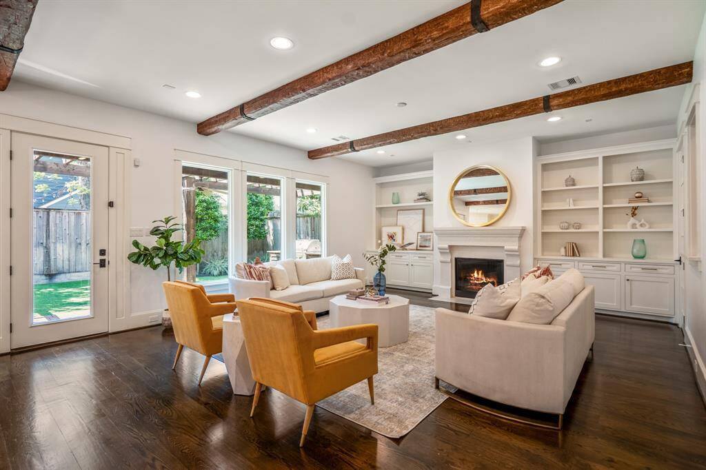 Framed by floor-to-ceiling windows, this light-filled family room is the heart of the home, opening effortlessly to the backyard and perfect for everyday connection and entertaining - even pre-wired for sound!