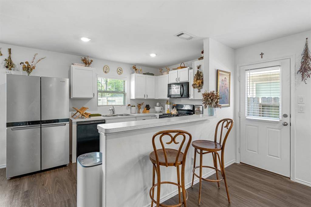 Kitchen (Refrigerator is included) Nice size breakfast bar and Door to the right goes out to back yard.