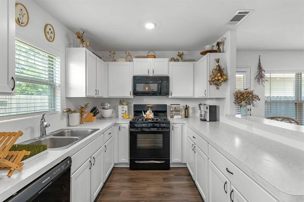 Modern Kitchen with Hardware on all Cabinets and Drawers.