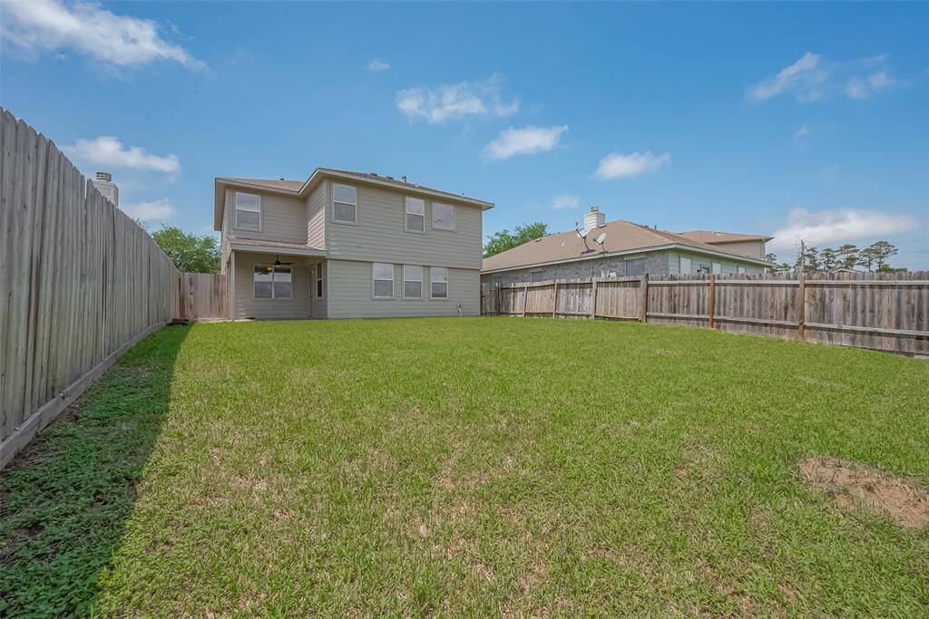 Spacious two-story home with a large fenced backyard, perfect for outdoor activities and gatherings.