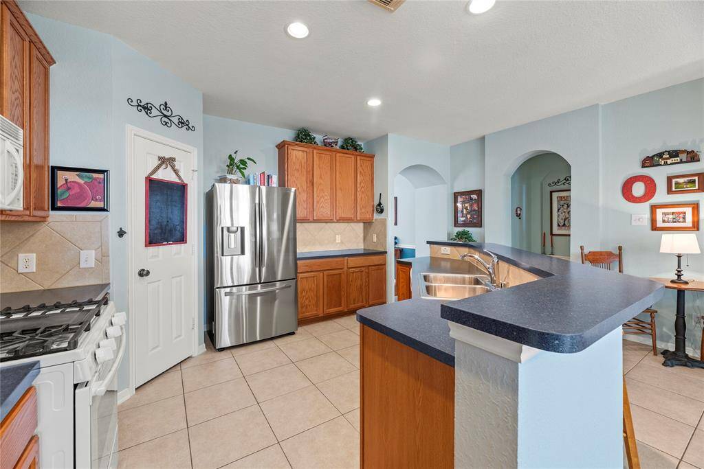 Alternate view of the kitchen showcasing its spacious and functional layout, designed for both convenience and style.