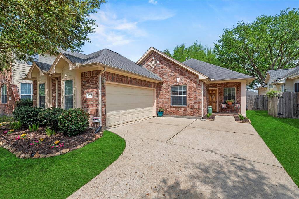 Front of the house featuring the driveway going to the two-car garage, and a welcoming front porch.