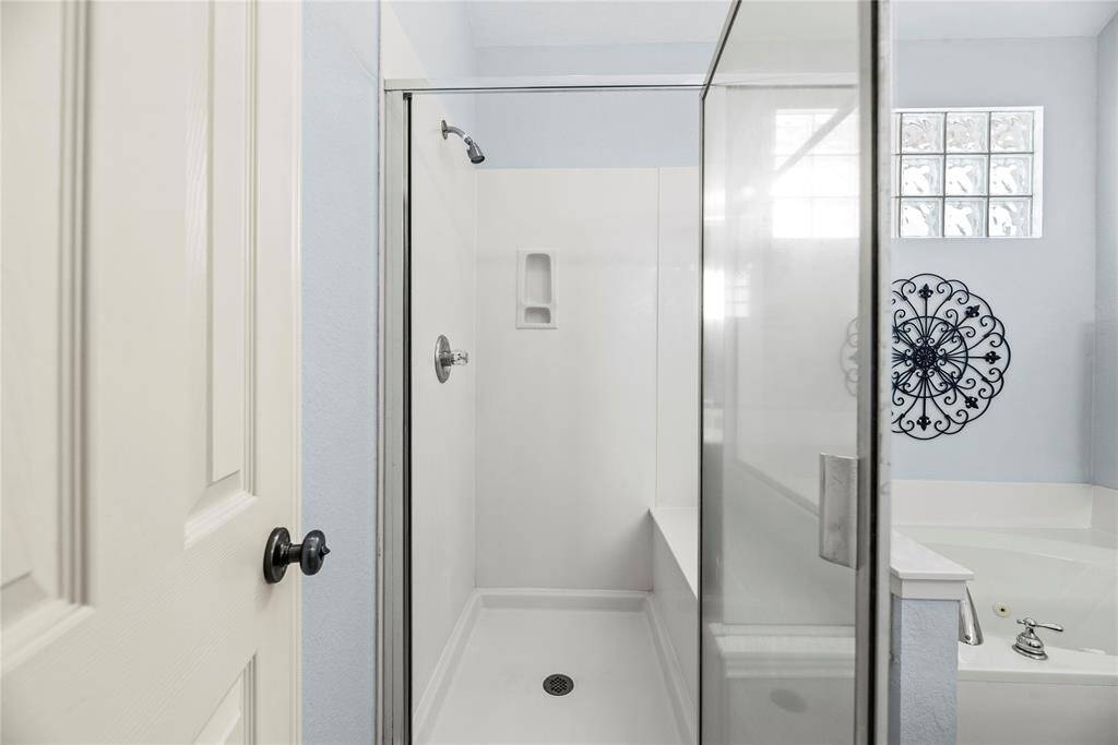 Glass-enclosed shower in the bathroom.