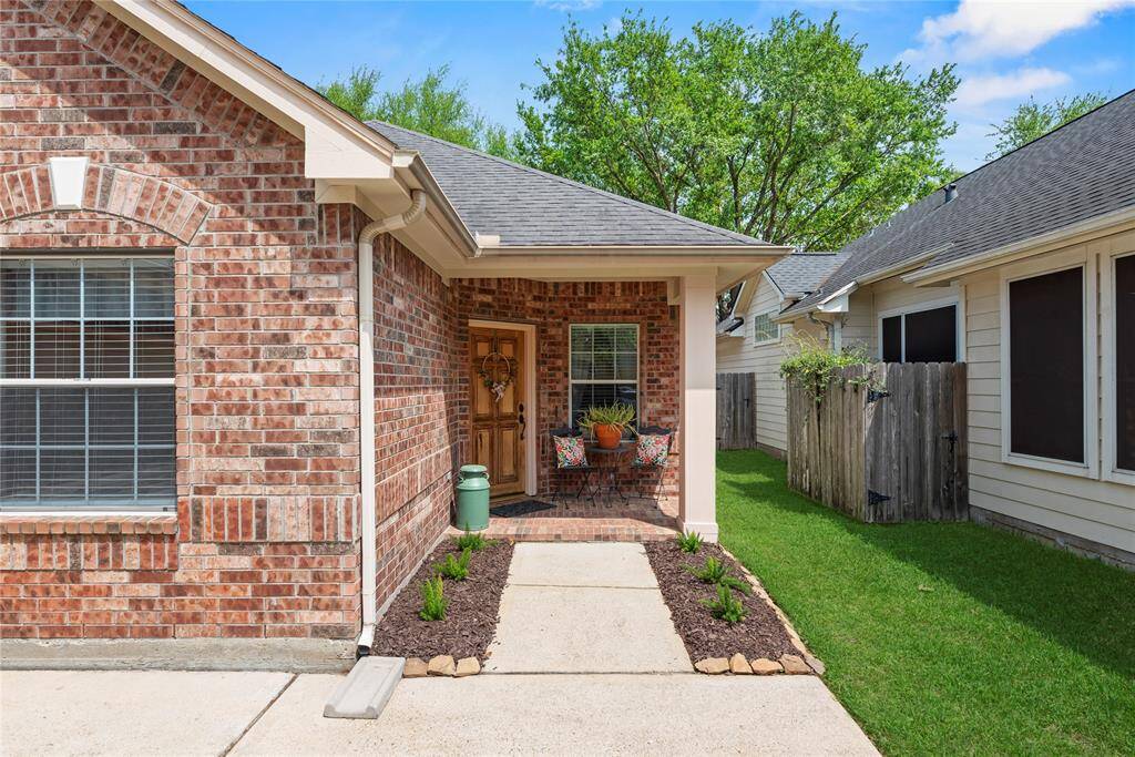 Front of the house featuring the welcoming front porch, and vibrant landscaping.