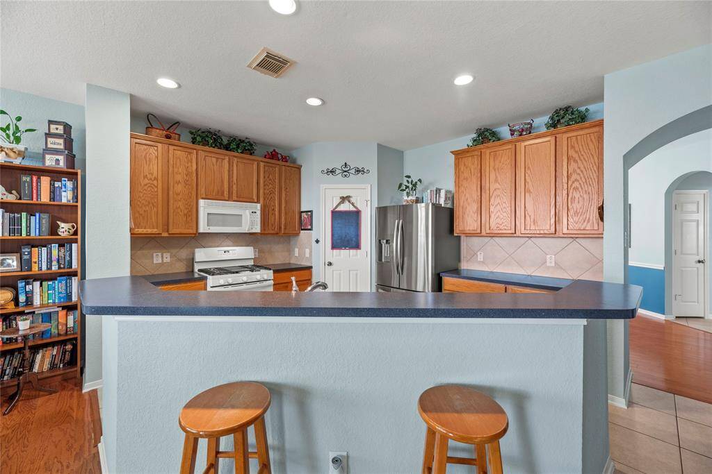 Alternate view of the kitchen featuring the island with seating.