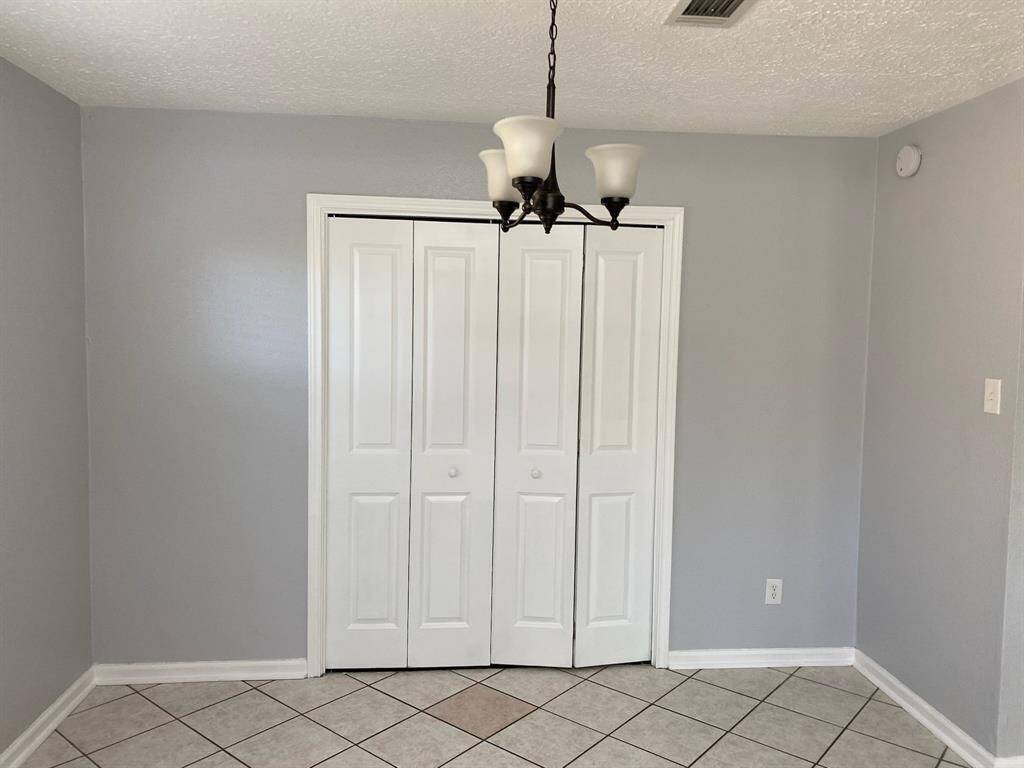 Laundry room is located behind the double doors near the kitchen