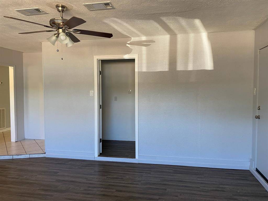 Ceiling fan and closet in large bedroom