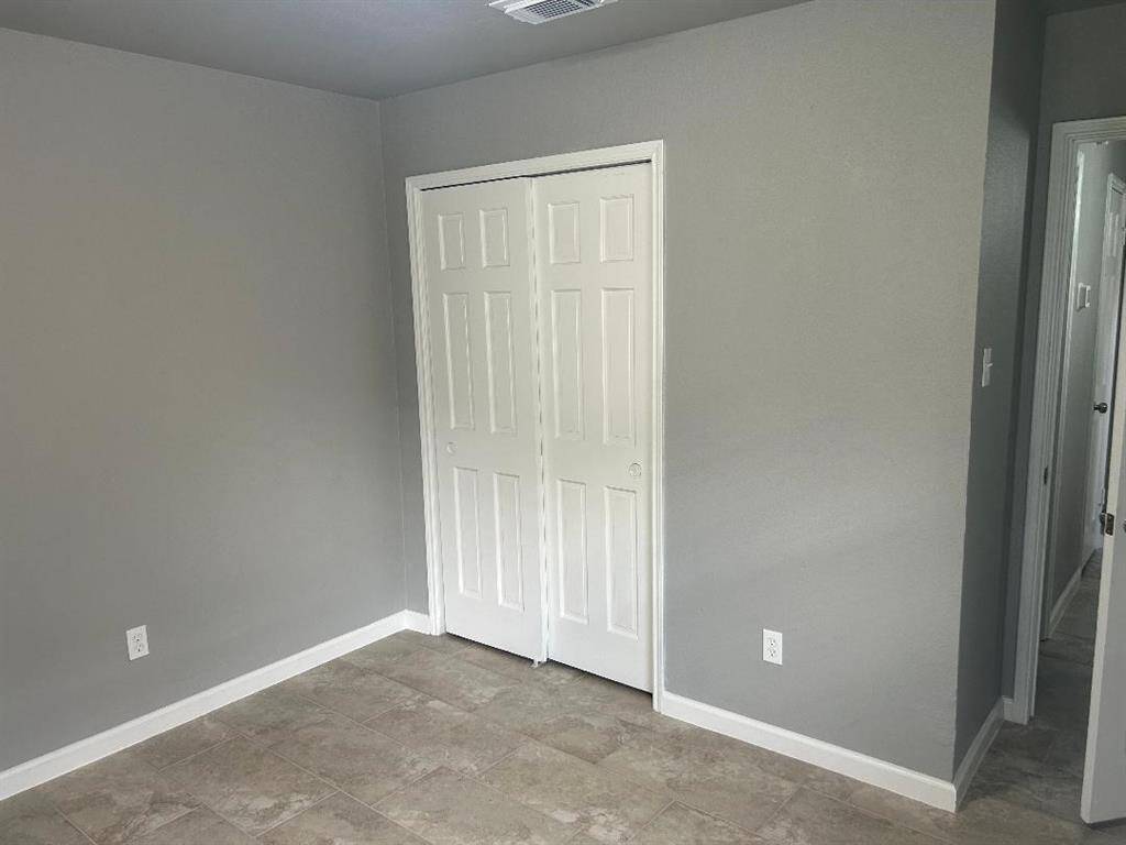Another view of corner front bedroom double-door closet space.