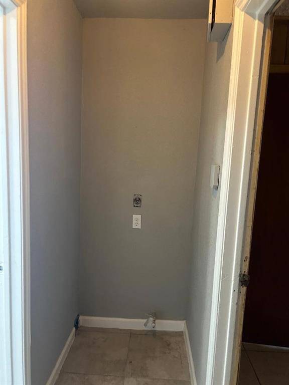 Laundry area with hookups for an electric dryer connection.