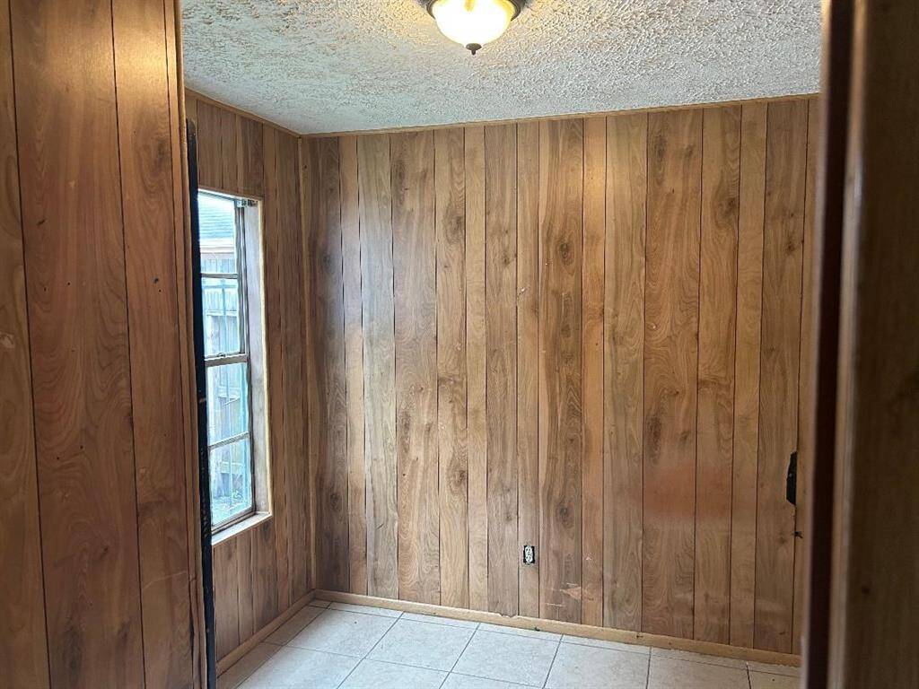 Study/Office features wood paneling on the walls and a view of the outside atrium.