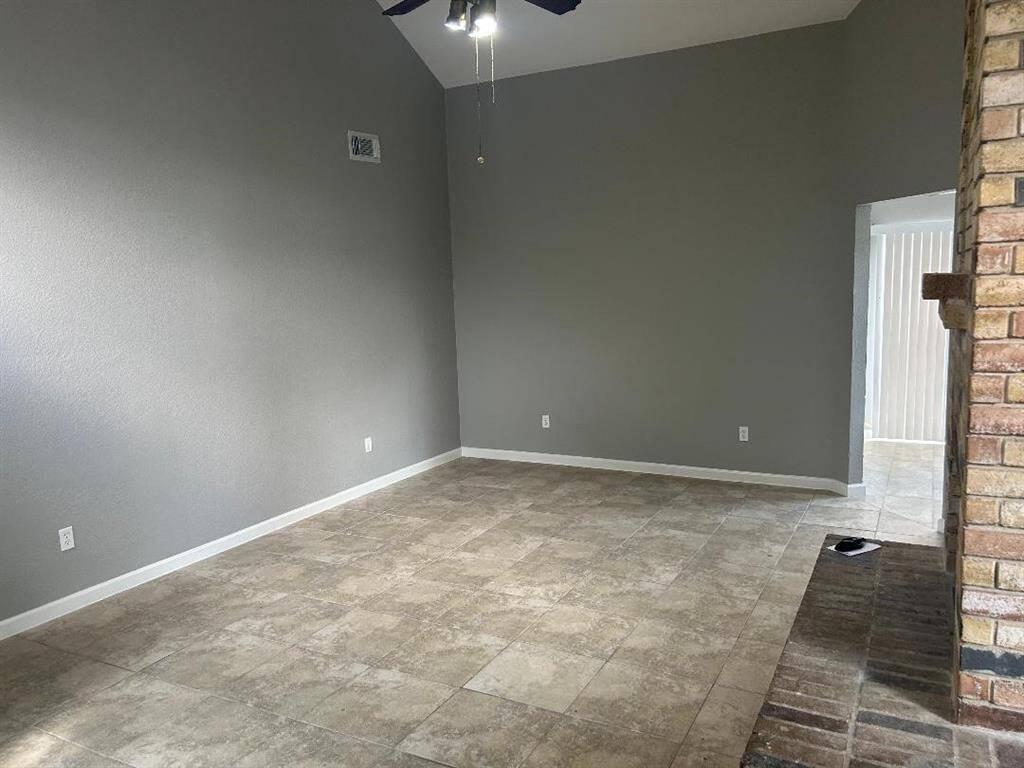 View of Living area from the entryway and opens into the kitchen.