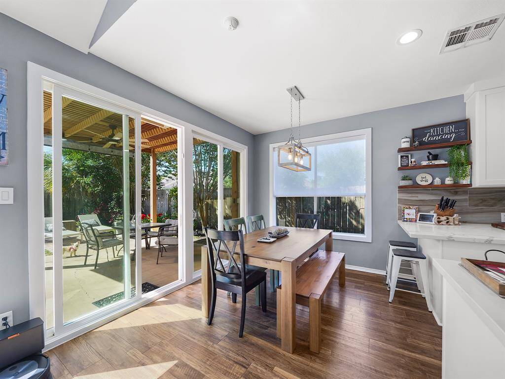 Indulge in the tranquility of backyard views from the sun-drenched breakfast nook, seamlessly connected to the kitchen. A serene space ideal for morning relaxation.