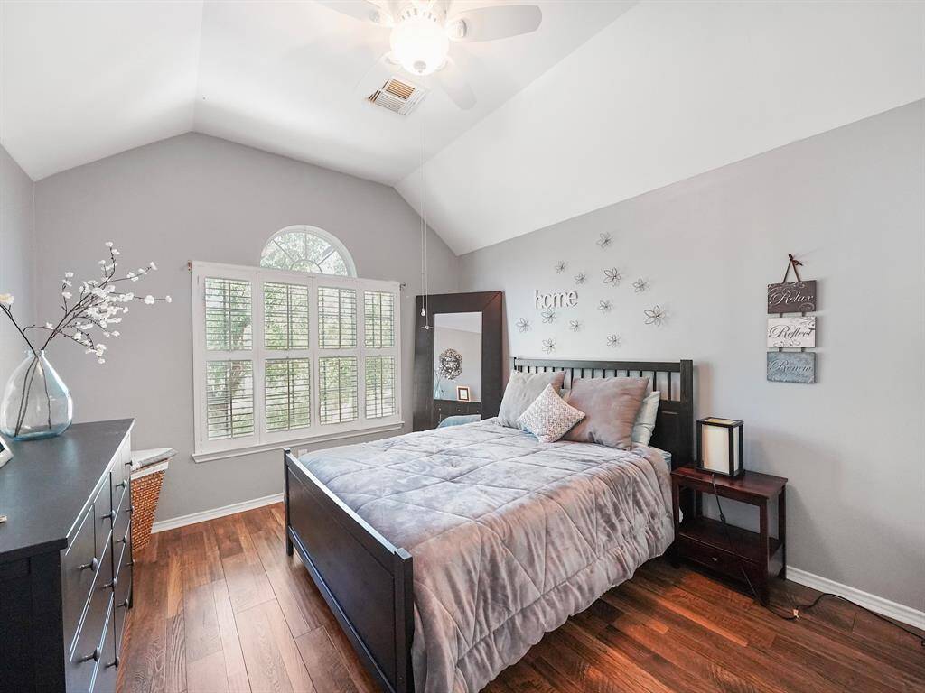The second floor of this home features three charming secondary bedrooms, each providing ample space for relaxation and rest. The first of these bedrooms boasts a beautiful vaulted ceiling and is adorned with classic plantation shutters, creating a bright and airy atmosphere.