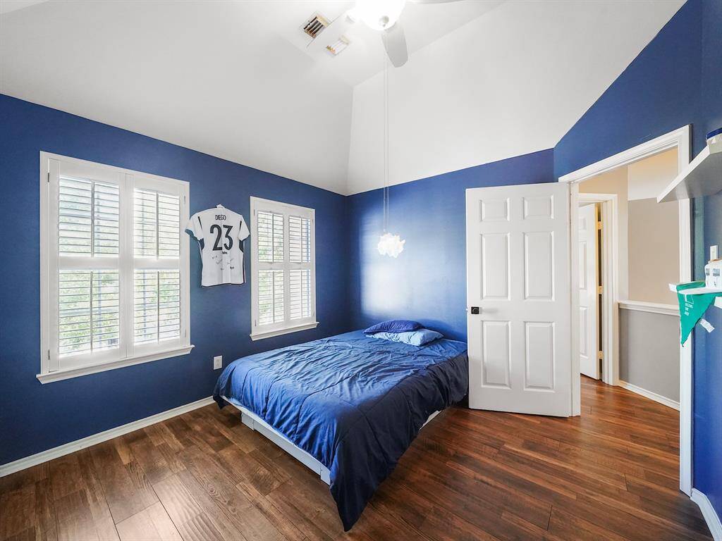 Secondary bedroom #2 offers high ceiling and plantation shutters.