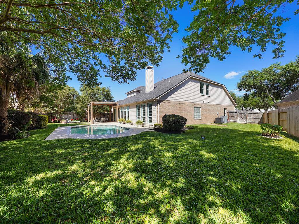 Enjoy ample green space for additional outdoor activities, making this backyard the ultimate retreat.