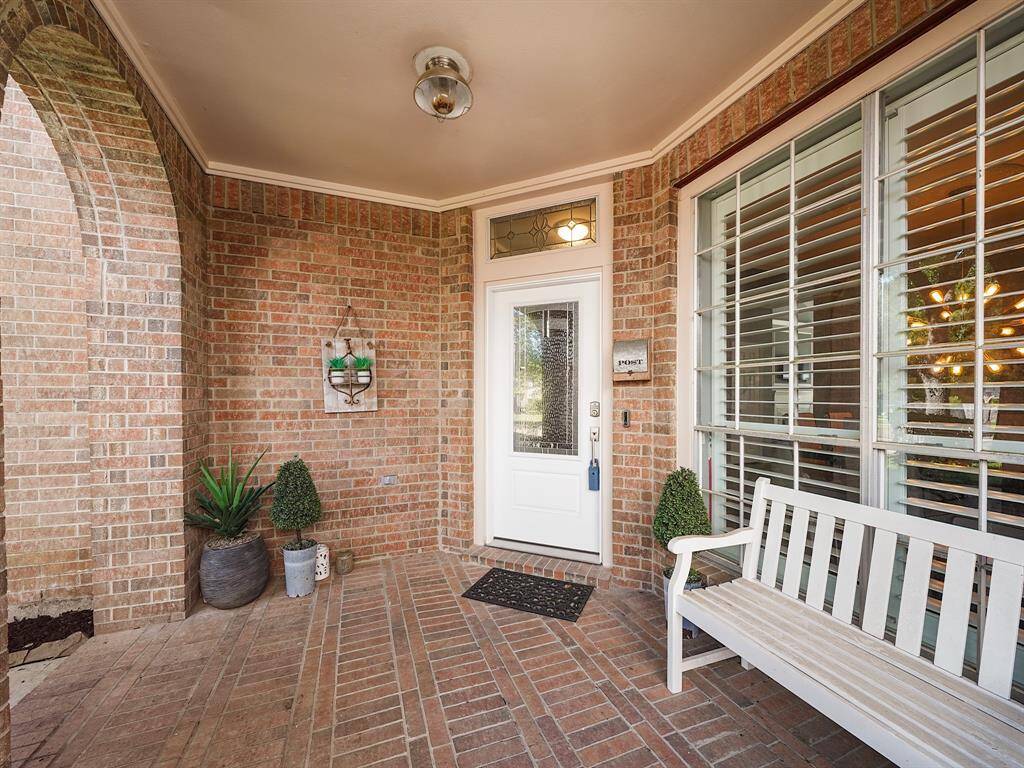 Enjoy the tranquility of the spacious covered front porch, ideal for outdoor seating and relaxation.