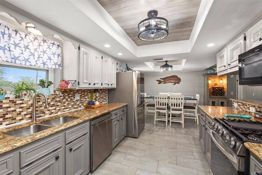 Galley kitchen with a custom ceiling treatment.