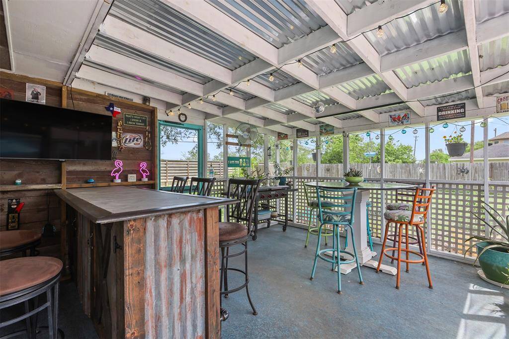 Outdoor terrace/bar with screened windows.