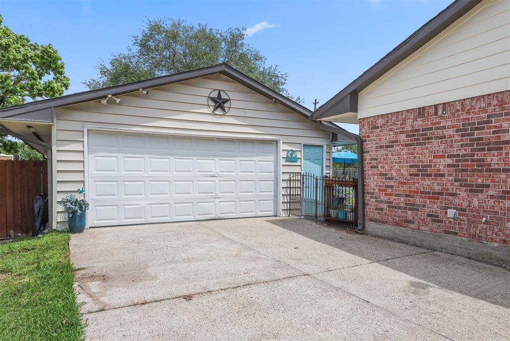 Wide driveway leads to a tandem 4 car garage.