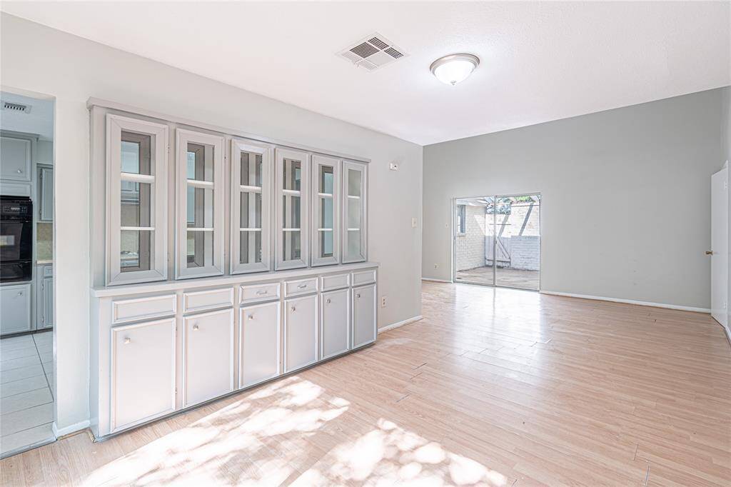 This formal dining space feels open and inviting, with great natural light and a classic built-in hutch for extra storage or display.