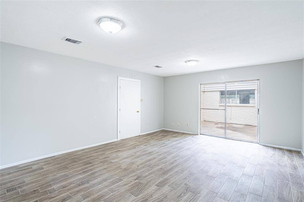 Primary bedroom filled with natural light, plus direct access to the courtyard for a relaxing outdoor escape.