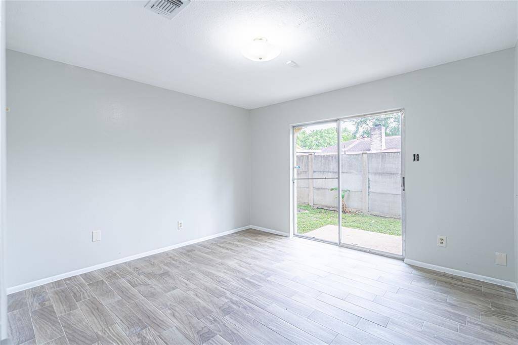 Bedroom two with direct access to the backyard is ideal for enjoying some fresh air right from your room.