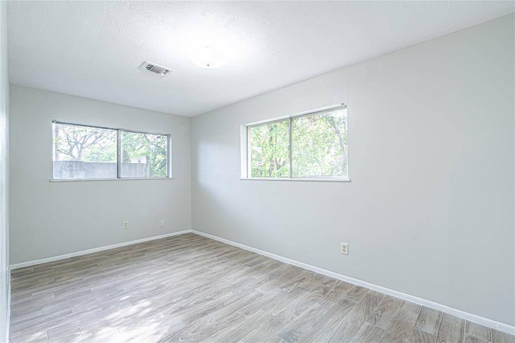 Bedroom four with plenty of natural light and stylish ceramic flooring. This room is bright and easy to maintain!