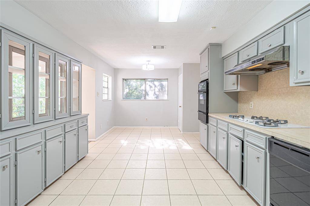 Sunny kitchen with ample storage, a breakfast nook full of natural light, and freshly painted cabinets to tie it all together.