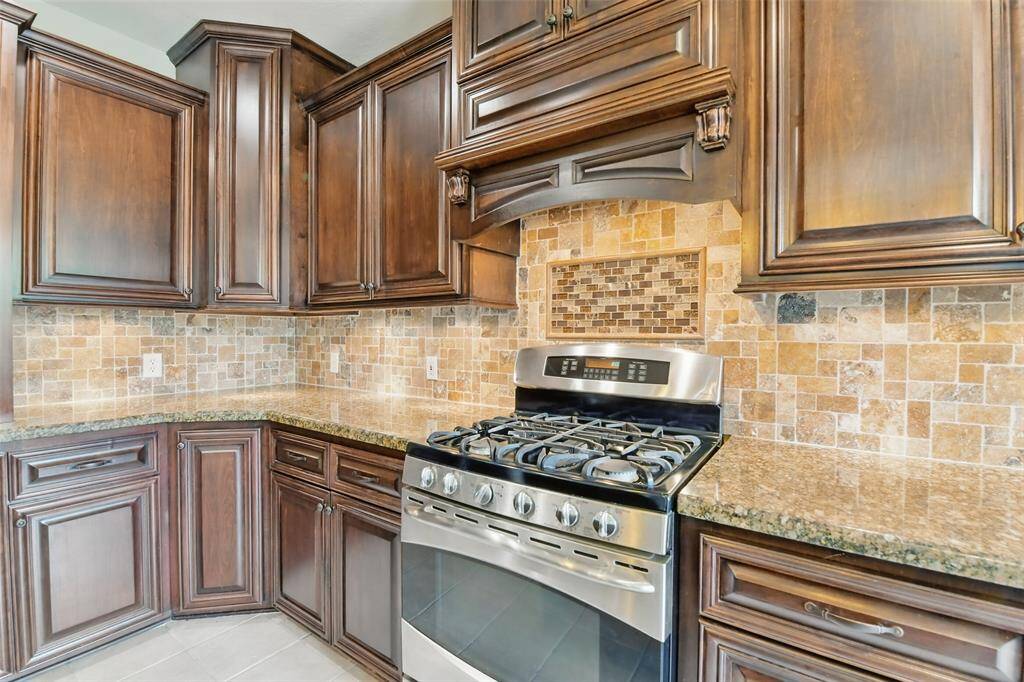 Cohesive elegant finishes are found throughout the kitchen. Don't miss that gas stove for easy cooking!