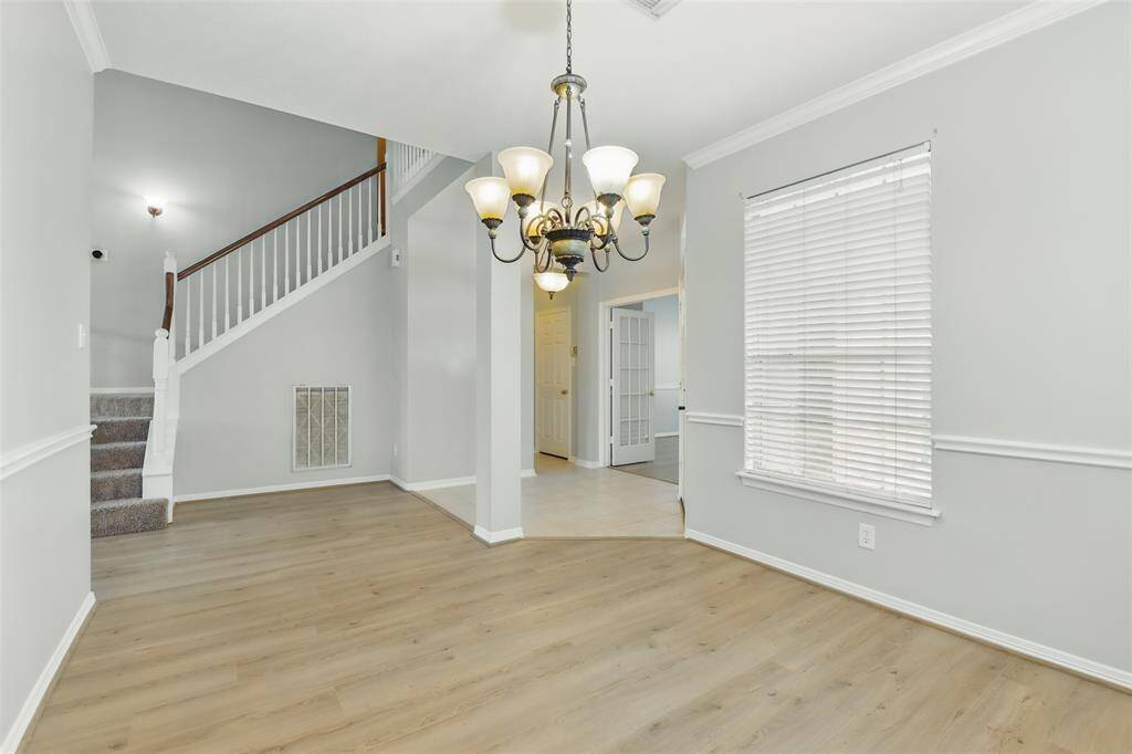 Standing in the formal dining room looking towards the stairway and office space.