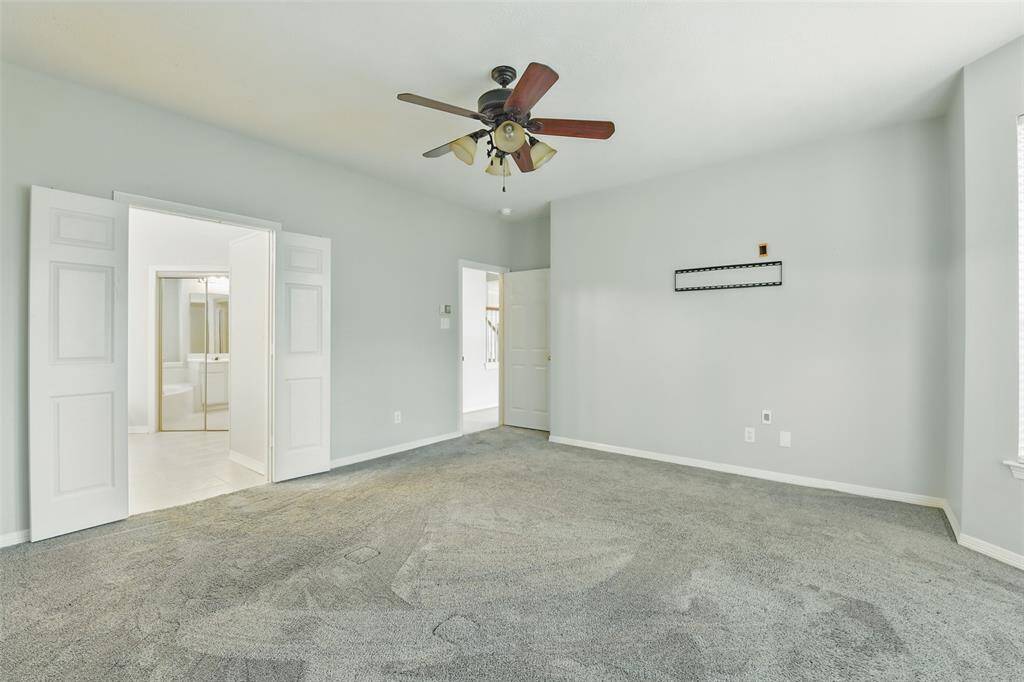 Ample space for your king-sized furniture. The double doors lead to the ensuite bathroom. Let's go check it out.