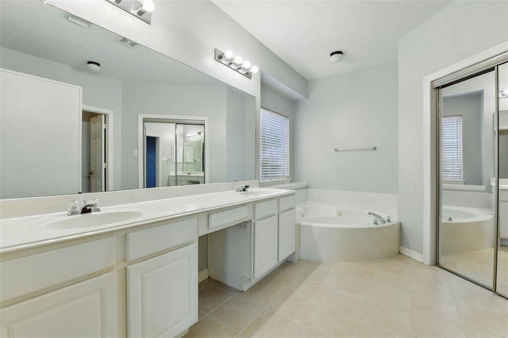 In the bathroom we find a large vanity area with double sinks, a large corner soaking tub, and a large walk-in closet.