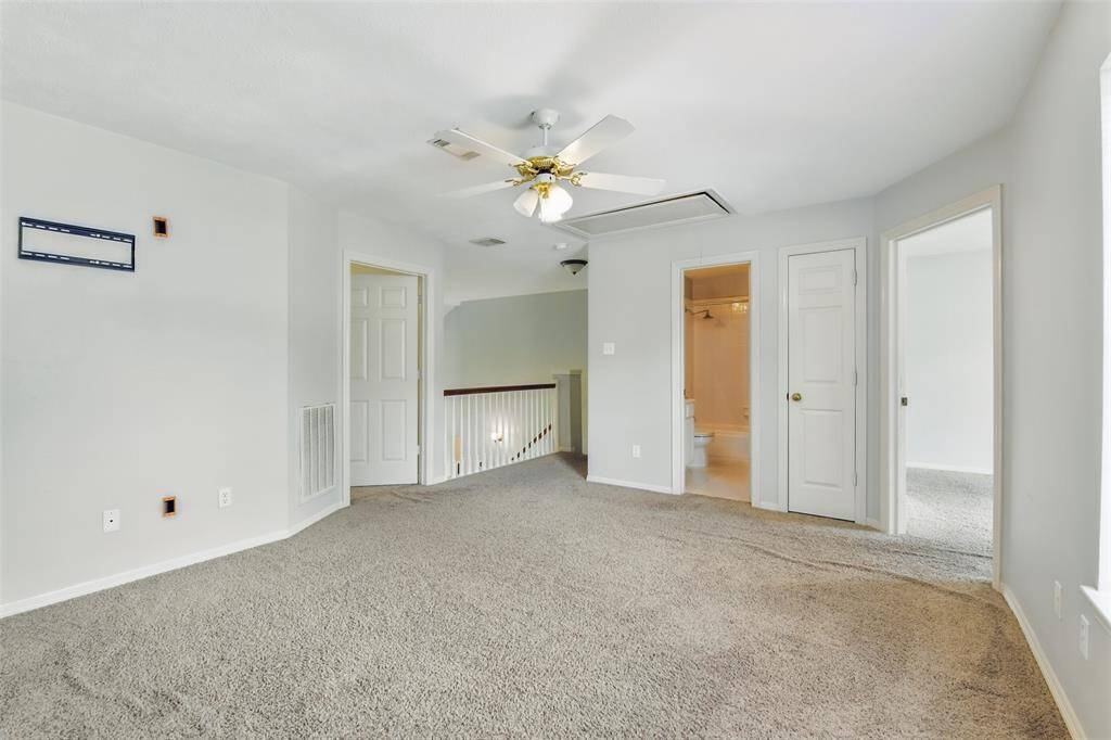 Standing in the game room looking back towards the stairs and we get a look at the secondary bedrooms and full sized bathroom.