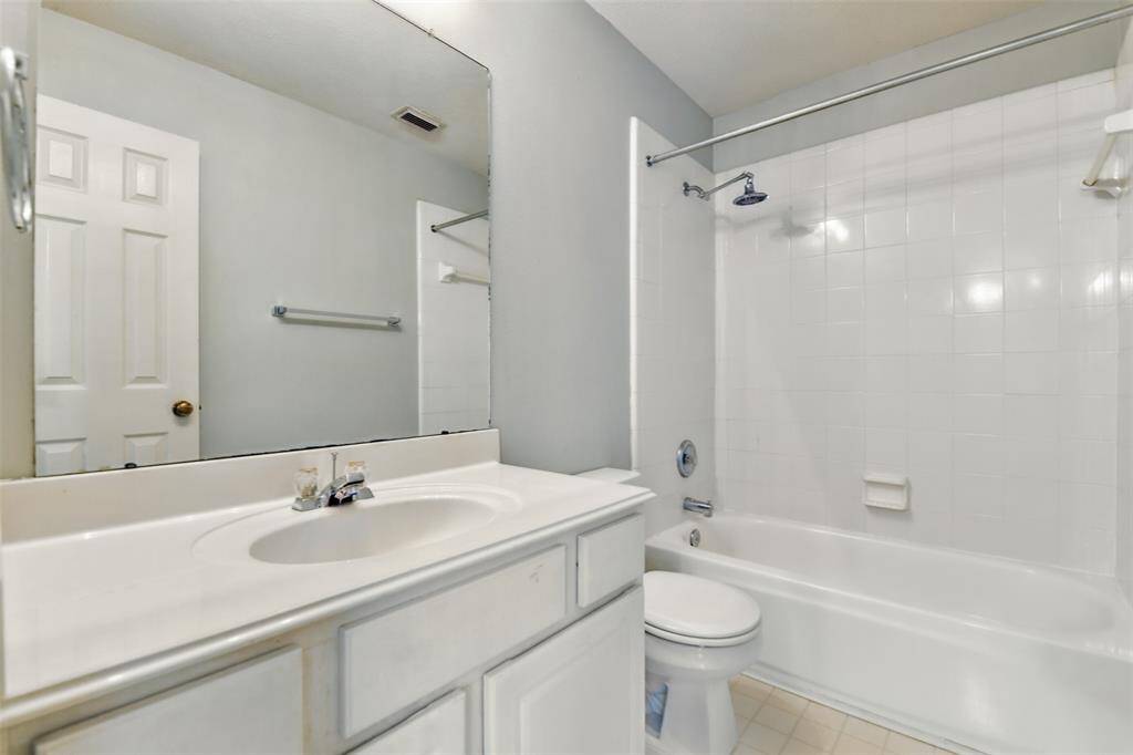 In the adjacent room is the full sized bathroom finished with a tub-shower combo.