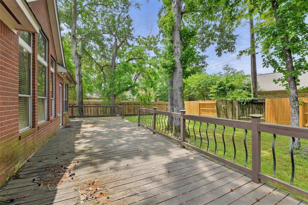 Enjoy your backyard BBQs with the large deck surrounded by mature trees.