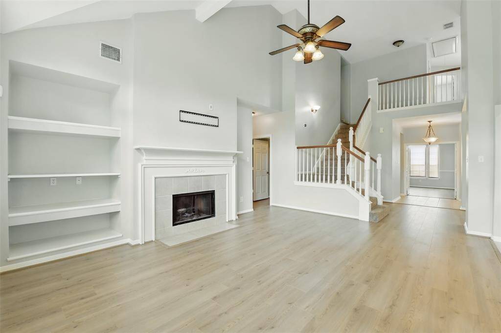 Anchored on the main wall is the gas fireplace and built-ins. From this angle we see our first look at the stairs leading to the room on the second story.