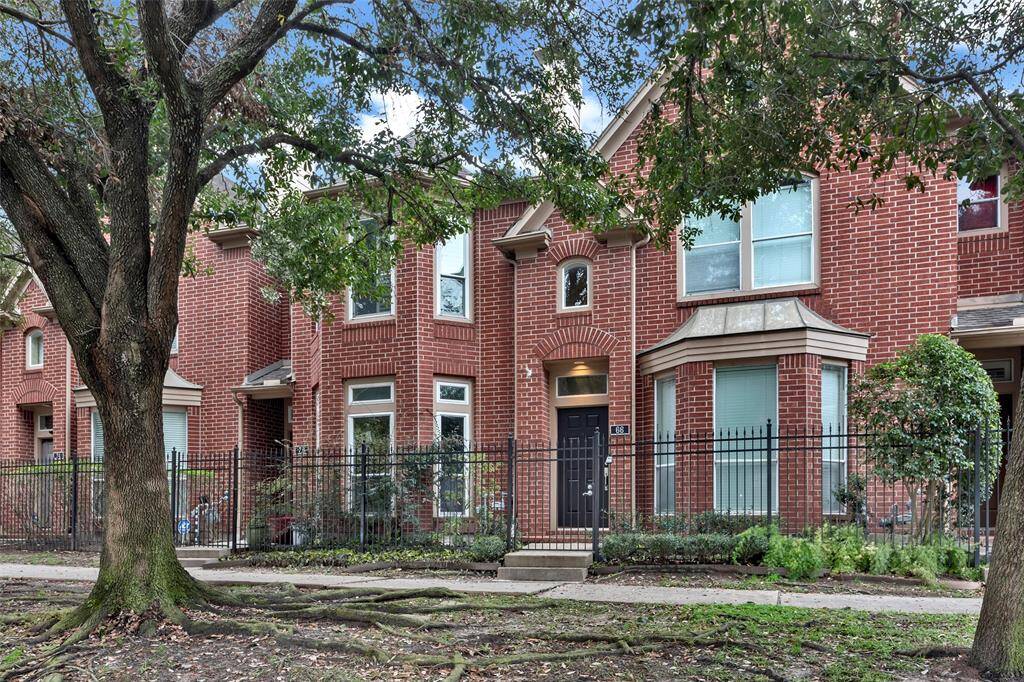 This charming townhome boasts a classic red brick exterior.