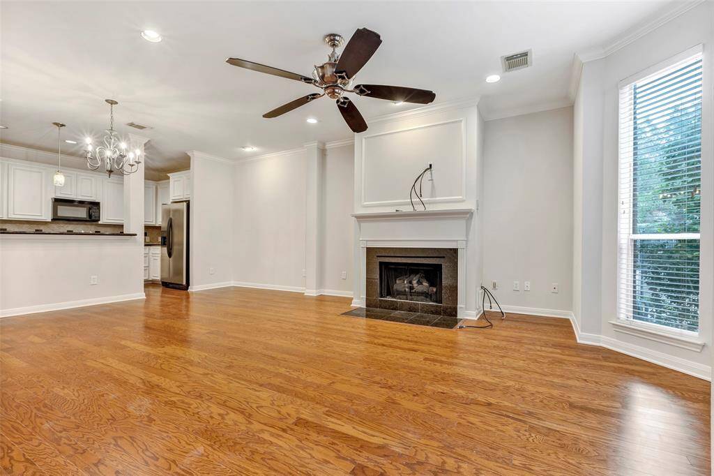 This cozy living area features a gaslog fireplace and stunning, shiny floors for a warm, inviting atmosphere.