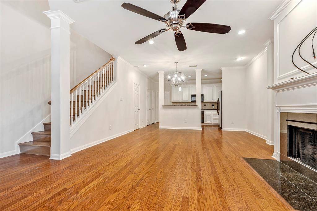 Another angle of the living room, showcasing the staircase leading to the second floor.