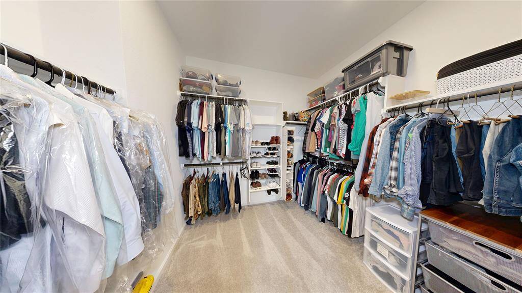 Expansive walk-in closet in the owner's suite, perfect for all your storage needs.