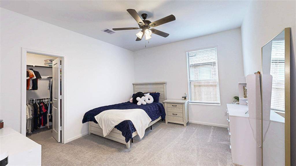 Inviting secondary bedroom with ample natural light and a spacious closet.